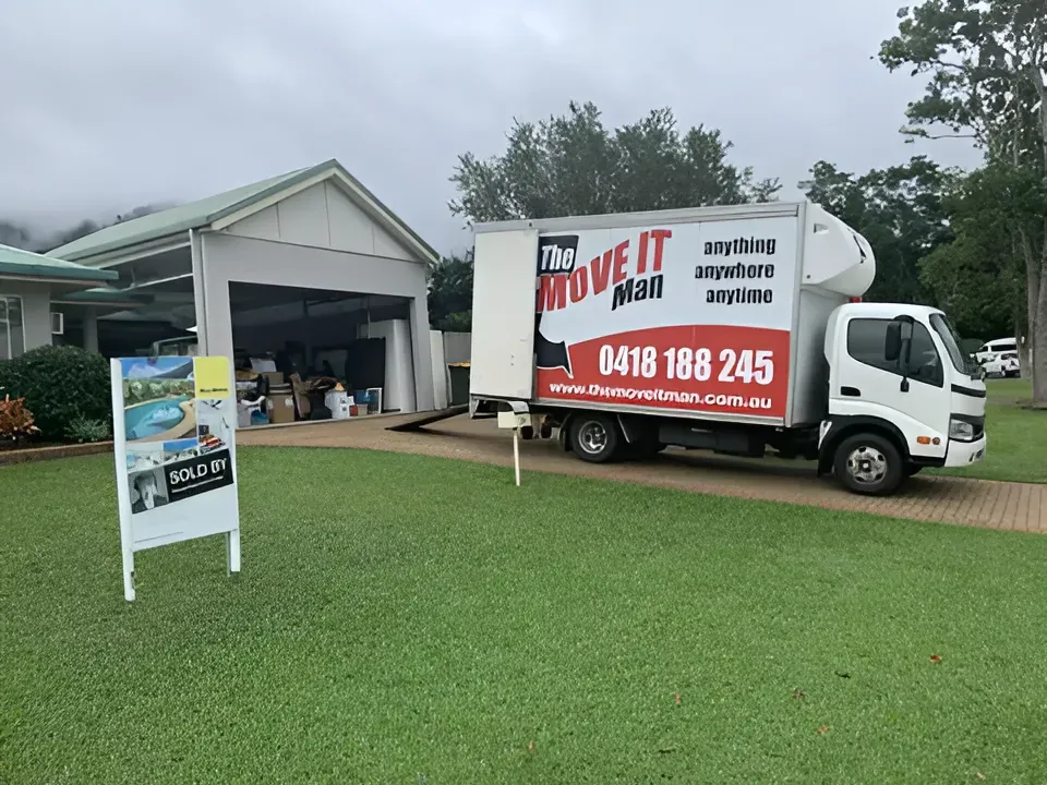 A Moving Truck Parked in Front of a House — The Move It Man In Cairns, QLD