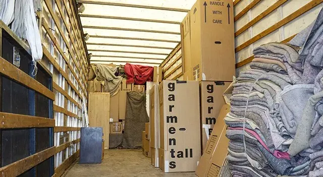 Inside of a Moving Truck, Filled With Boxes, Fabric Bundles, and Furniture — The Move It Man In Cairns, QLD