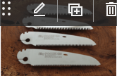 Three Saw Blades Are Sitting On A Wooden Table — Tree Arrangements in Stratford, QLD