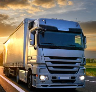 Semi-truck Driving on a Road at Sunset, Sun Shining Brightly — Hines Logistic Pty Ltd In Kundabung, NSW