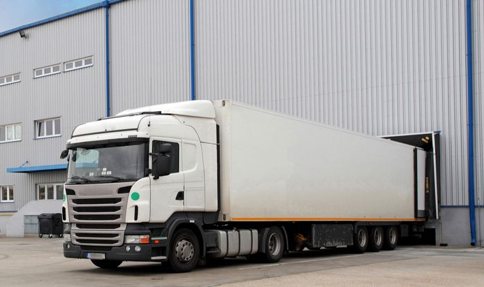 White Semi-truck Loading at a Warehouse Dock — Hines Logistic Pty Ltd In Kundabung, NSW