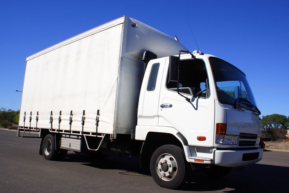 White Box Truck on Asphalt Road Against a Blue Sky — Hines Logistic Pty Ltd In Tamworth, NSW