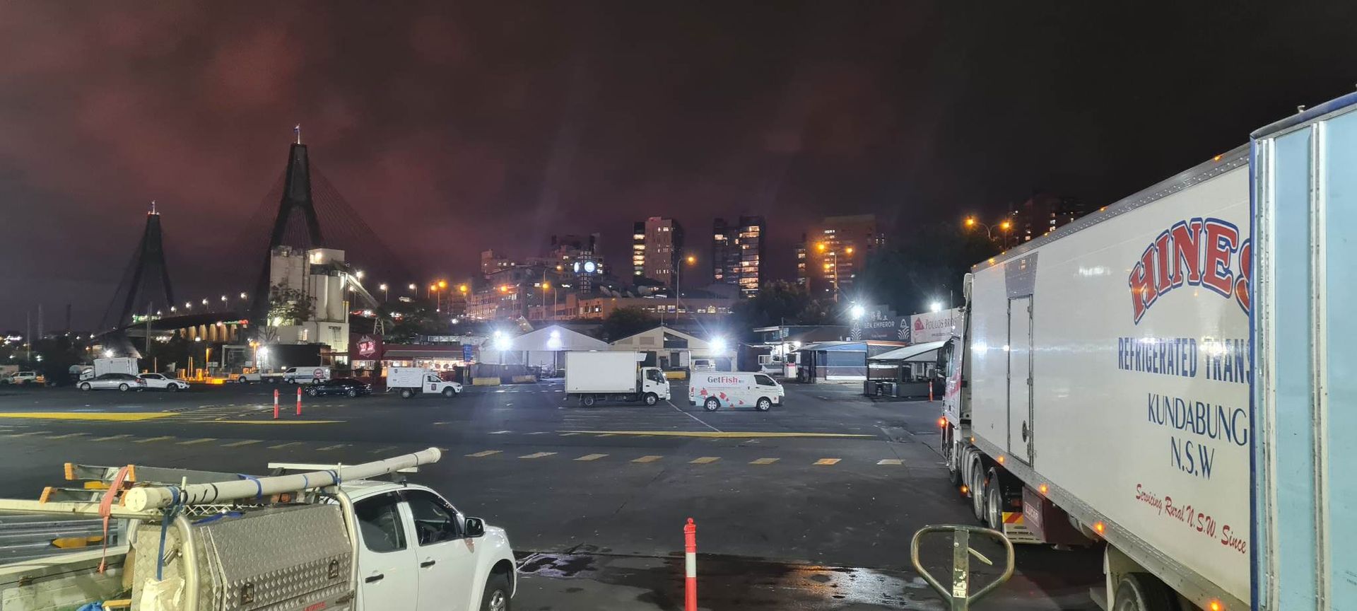 Night View of a Bridge and a City With Trucks in a Parking Lot — Hines Logistic Pty Ltd In Kundabung, NSW