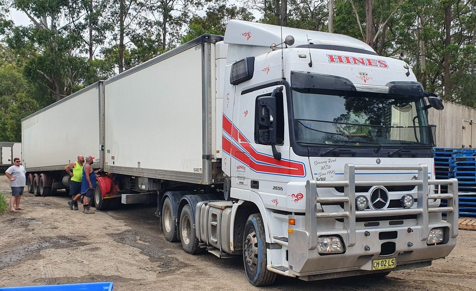 White Box Truck on a Crosswalk in an Urban Area, Between Brick and Glass Buildings — Hines Logistic Pty Ltd In Inverell, NSW