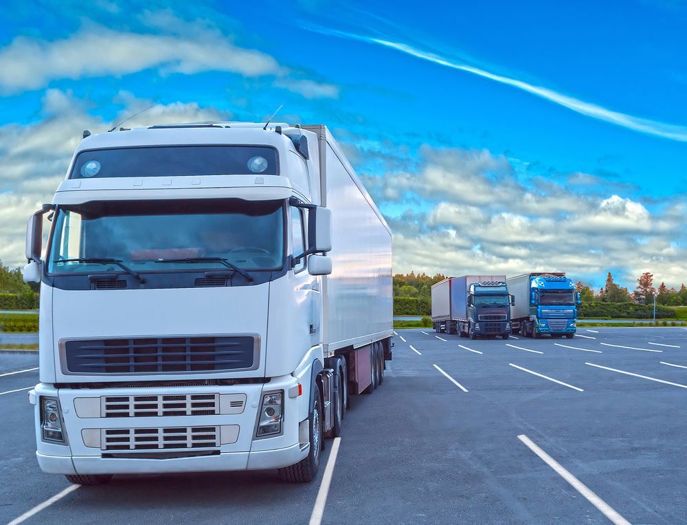 White Semi-truck Parked in a Lot, With Two Other Trucks — Hines Logistic Pty Ltd In Sydney, NSW