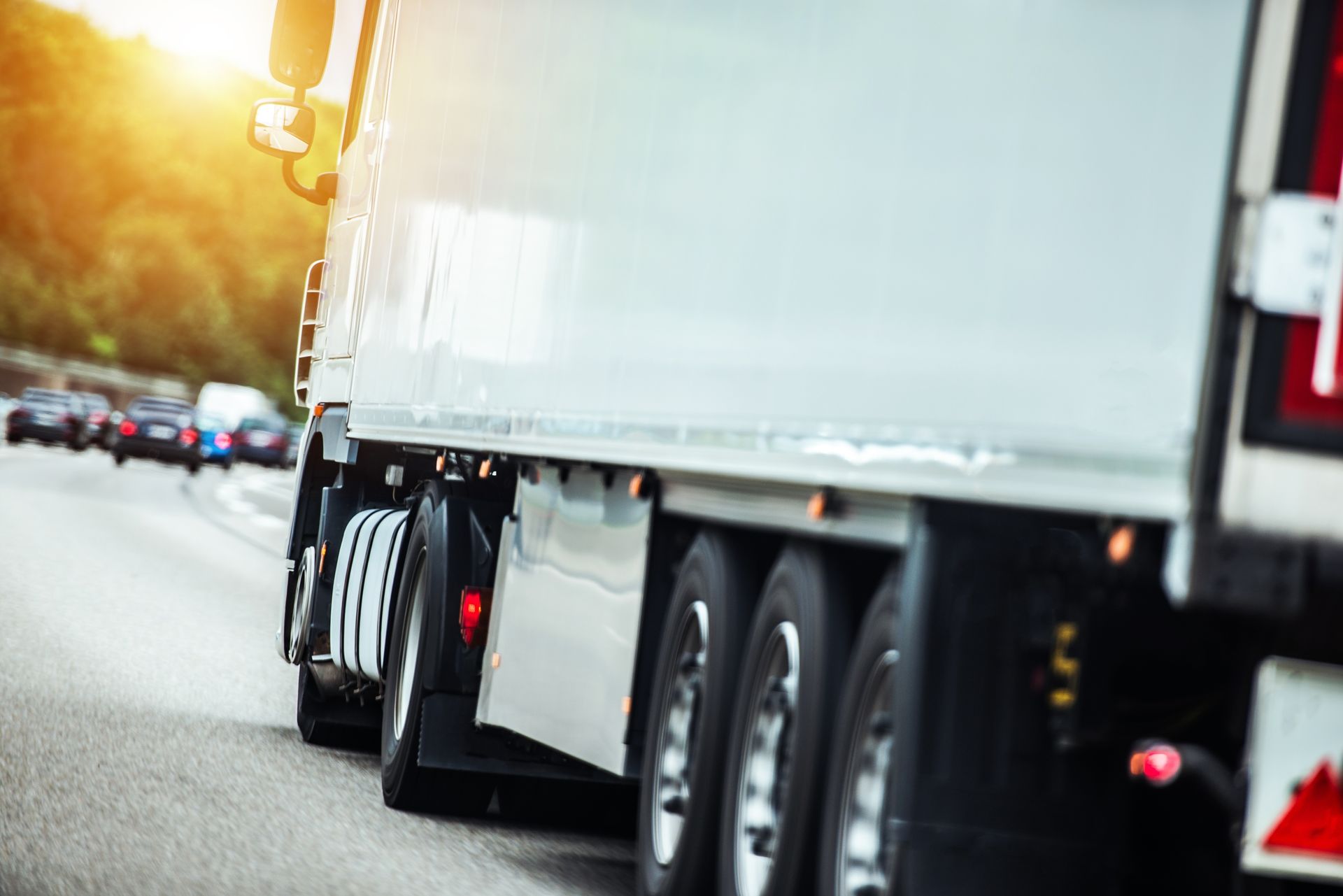 White Semi-truck Driving on a Highway, Other Cars in the Background, Sun Shining — Hines Logistic Pty Ltd In Armidale, NSW