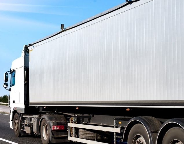 White Semi-truck Driving on a Highway Under a Bright Blue Sky — Hines Logistic Pty Ltd In Maitland, NSW