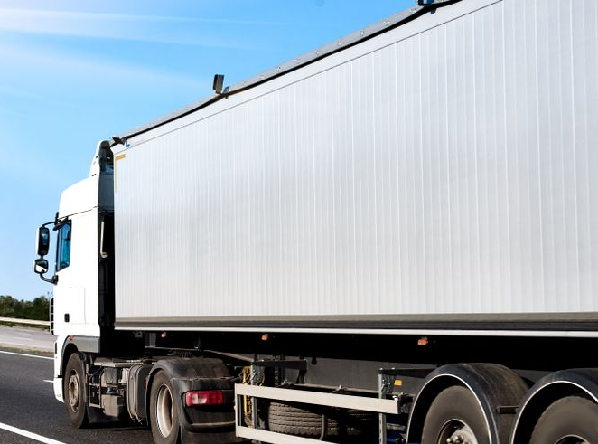 White Semi-truck Driving on a Highway Under a Blue Sky With Sunlight — Hines Logistic Pty Ltd In Kundabung, NSW