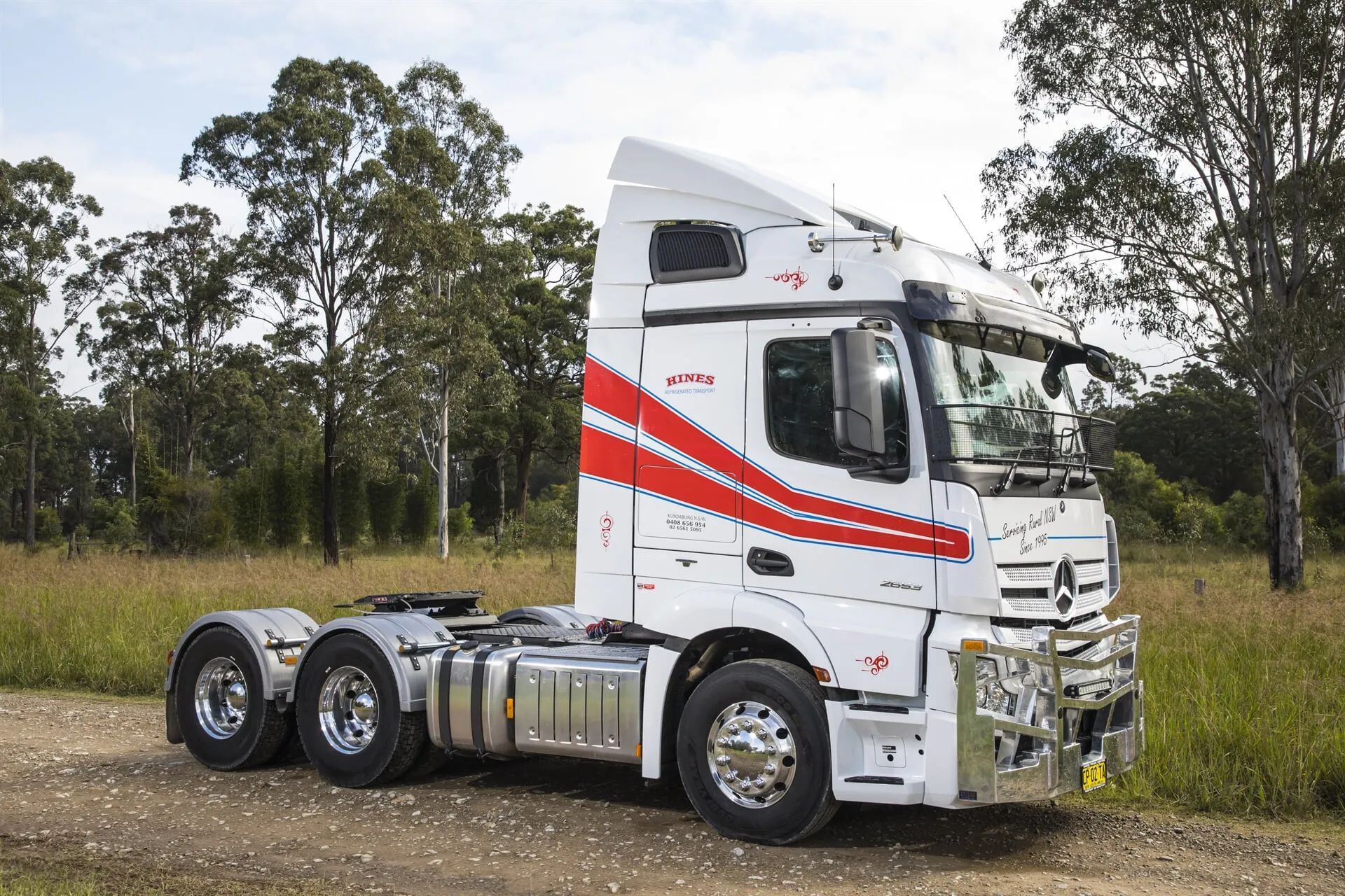 White Semi-truck With Red Accents Parked on a Dirt Road, Trees — Hines Logistic Pty Ltd In Forster, NSW