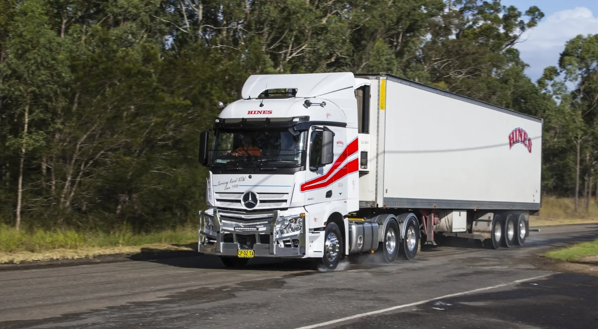 White Semi-truck With Red Accents Driving on a Paved Road — Hines Logistic Pty Ltd In Tamworth, NSW