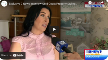 A woman in a pink shirt is being interviewed by a news reporter