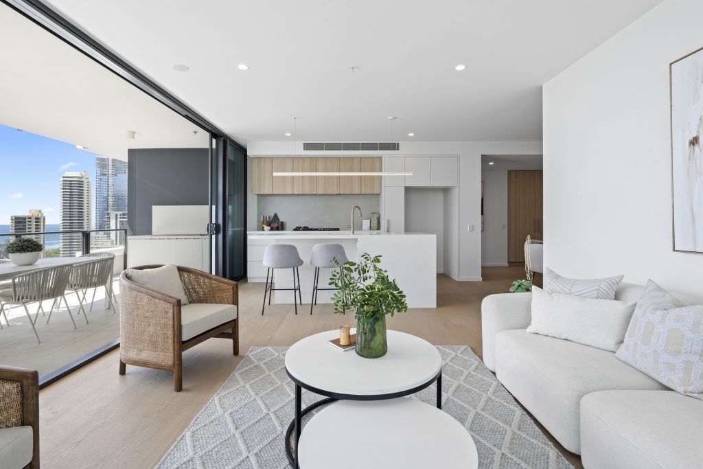 A living room with a couch , chairs , and a table.