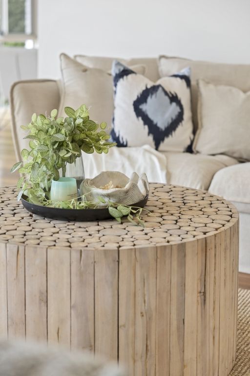 A wooden coffee table in a living room next to a couch.
