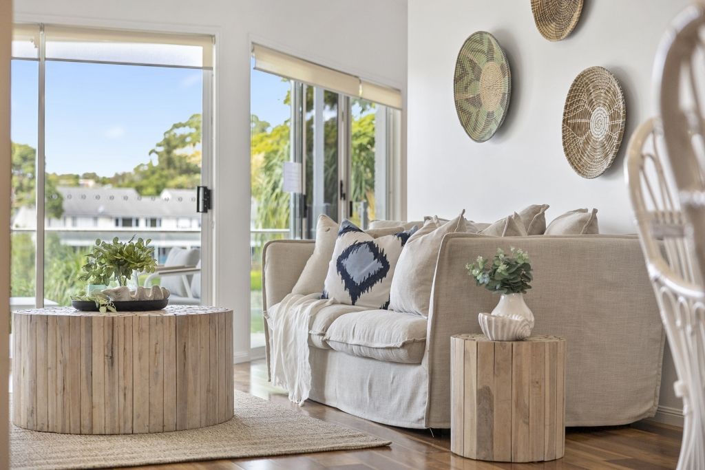 A living room with a couch , coffee table , and chairs.