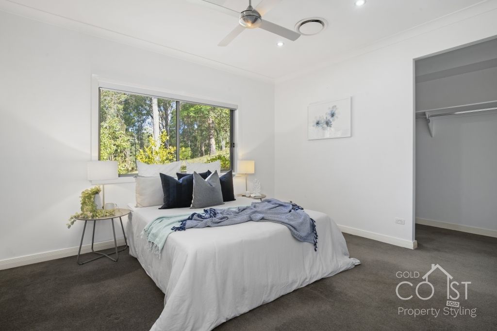 A bedroom with a large bed and a ceiling fan.