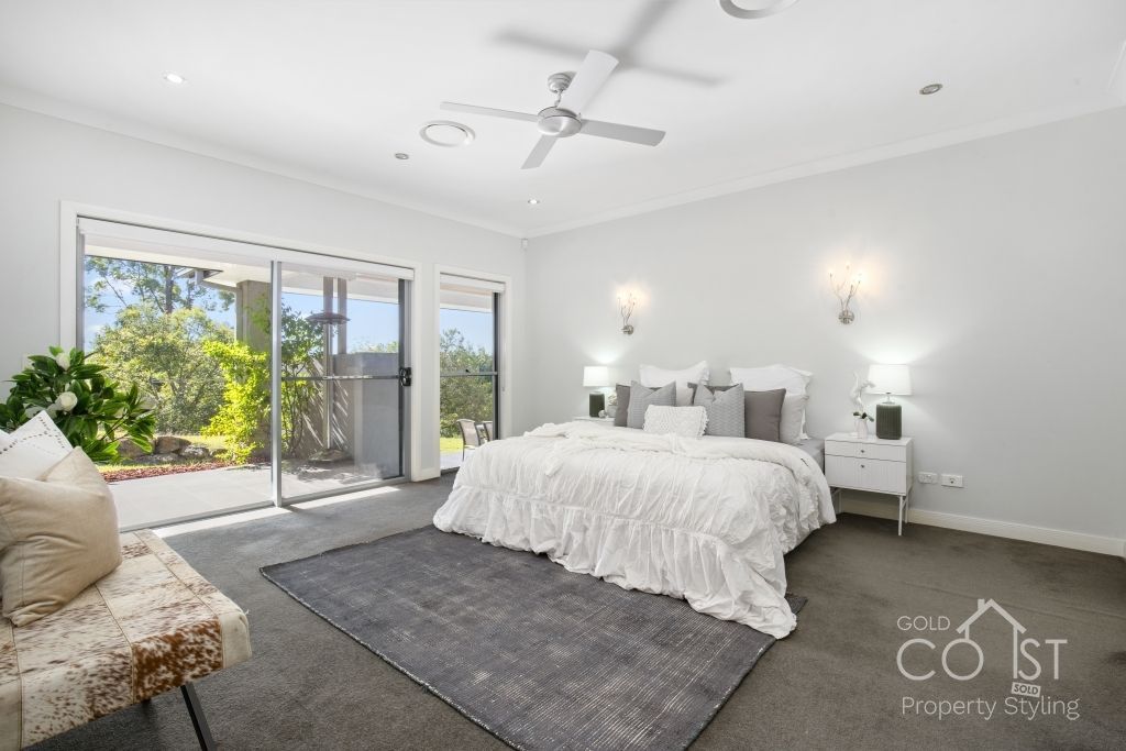 A bedroom with a large bed and a sliding glass door