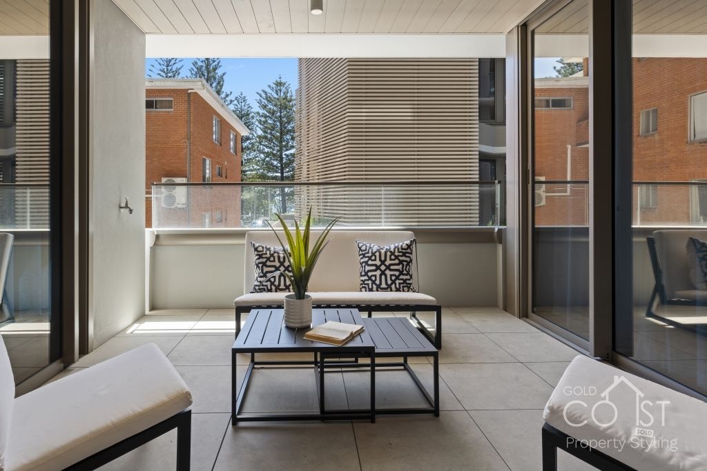 A balcony with a couch and a coffee table
