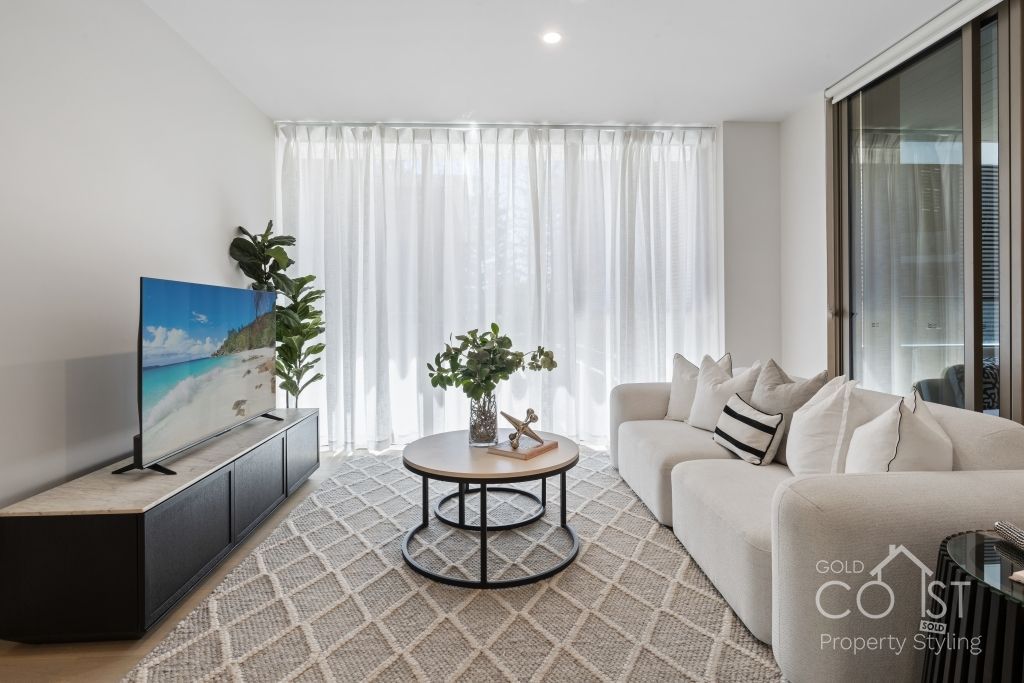 A living room with a couch , table , and television.