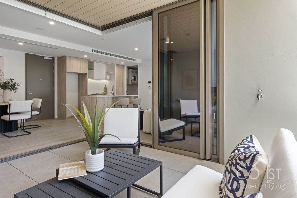 A living room with a table and chairs and a sliding glass door