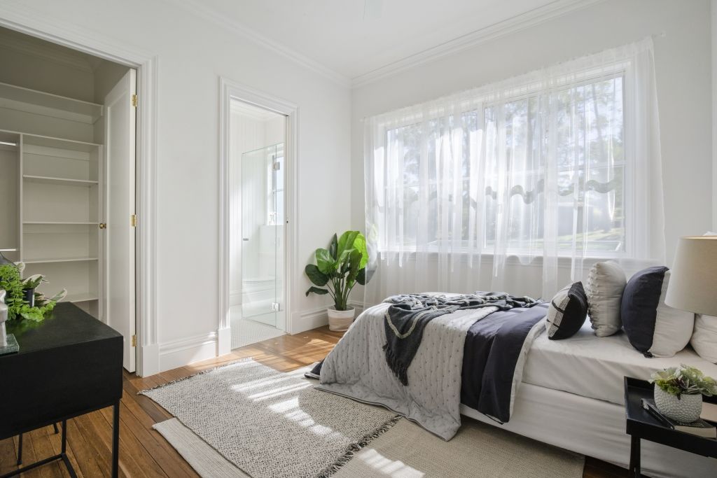 A bedroom with a bed and a couch in it.