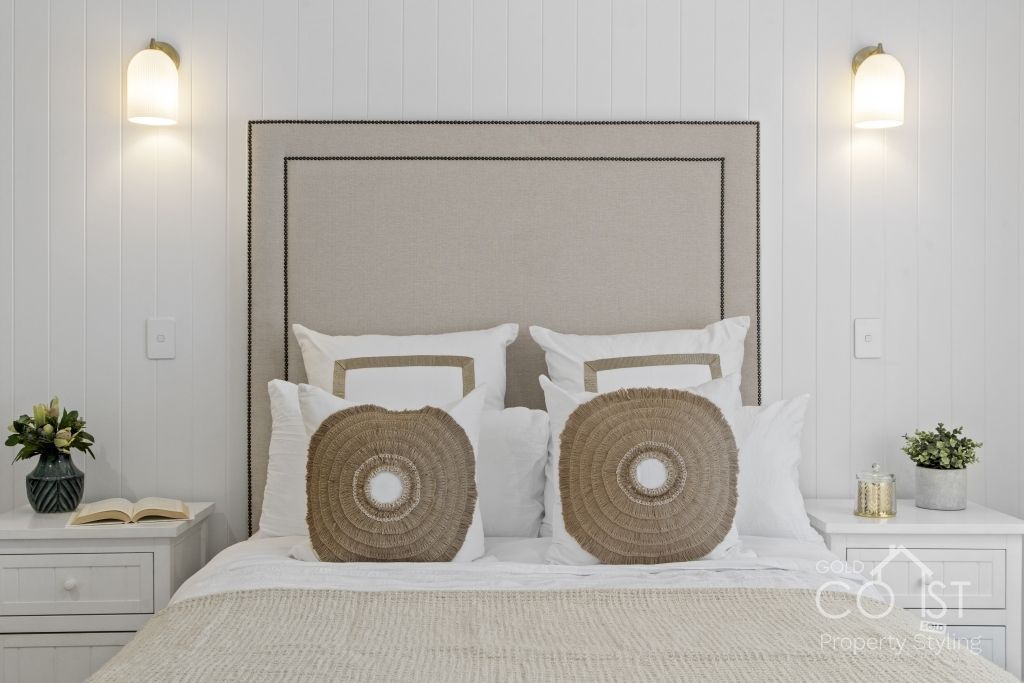 A bedroom with a bed , nightstand , and headboard.
