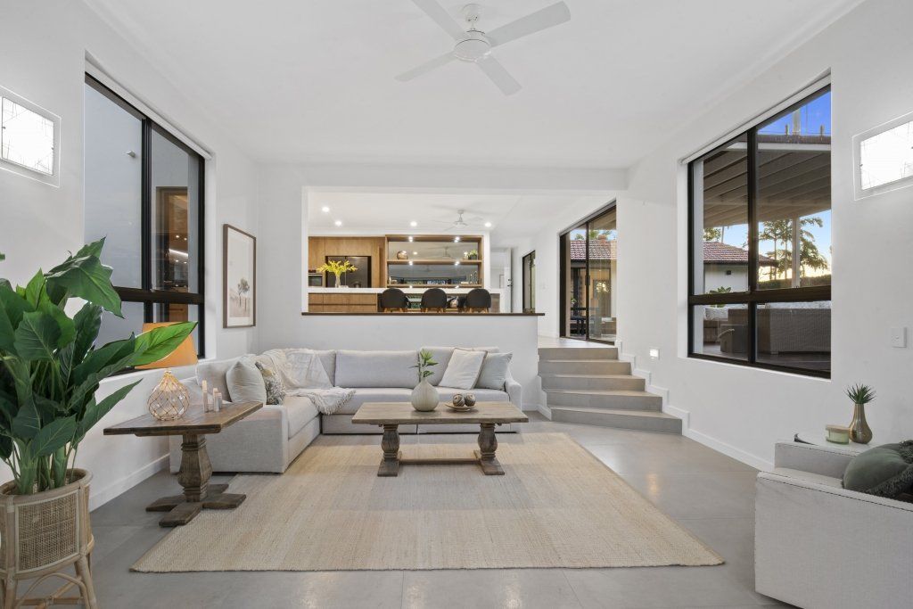 A living room filled with furniture and a ceiling fan.