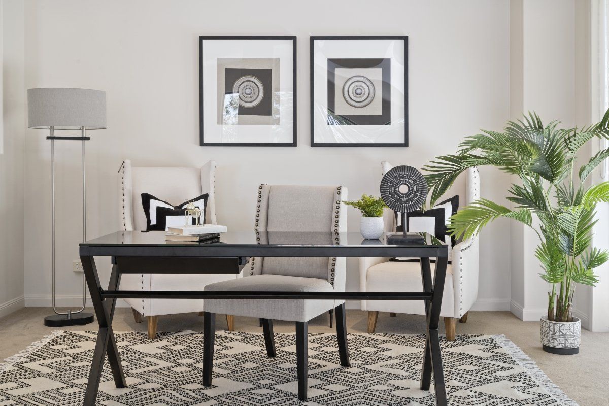 There is a desk and chairs in the room.