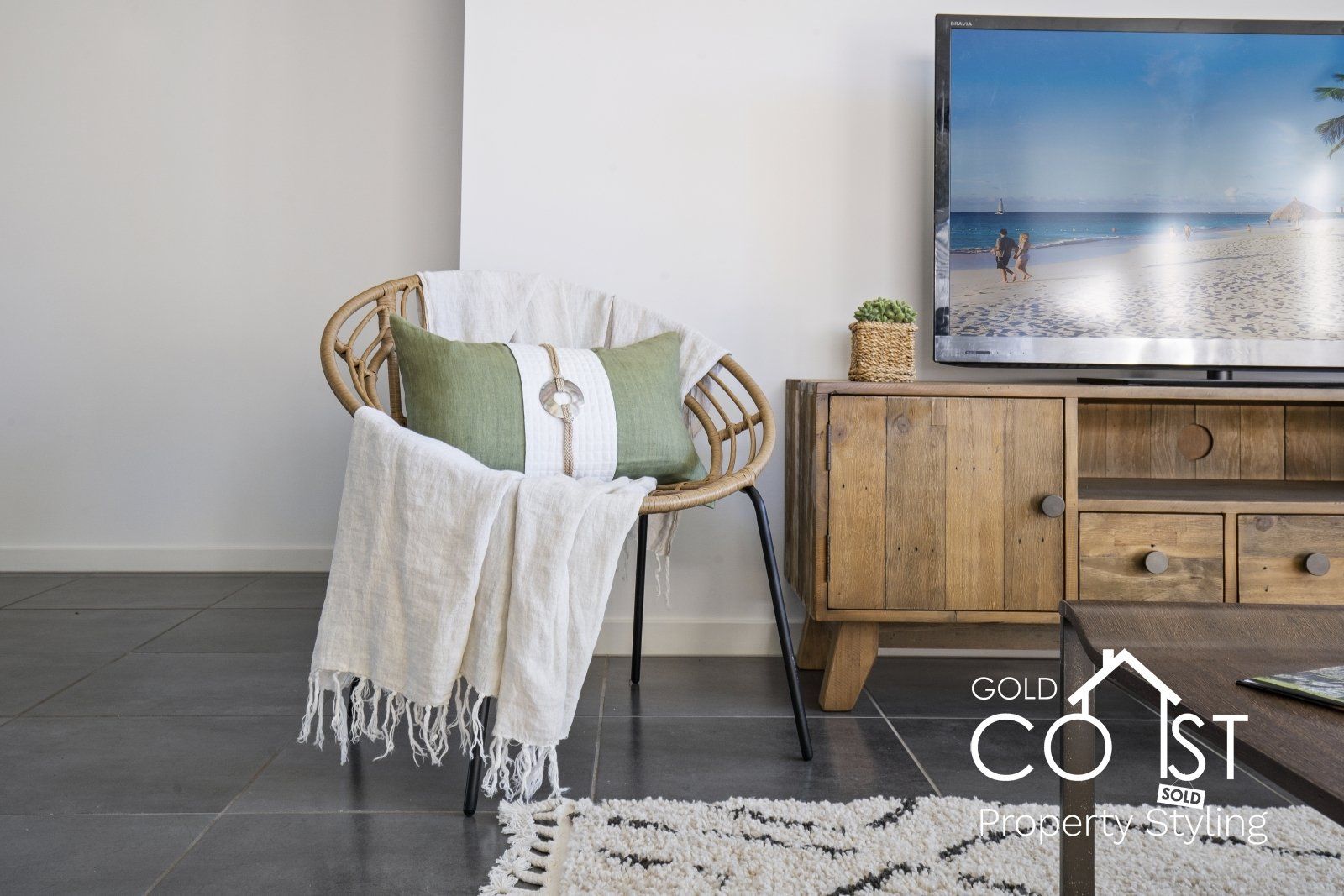 A living room with a chair and a television.
