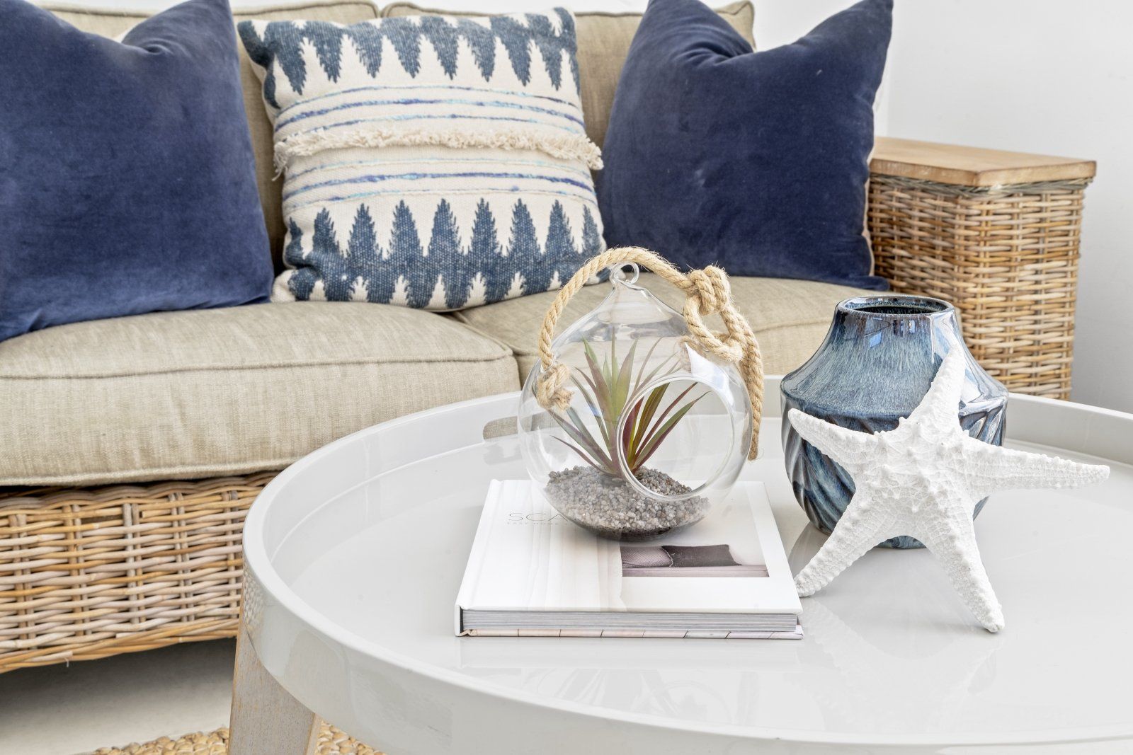 A living room with a couch and a table with a book on it.