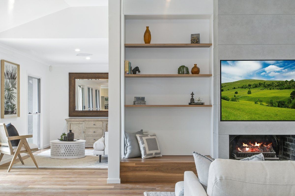 A living room with a fireplace and a flat screen tv.
