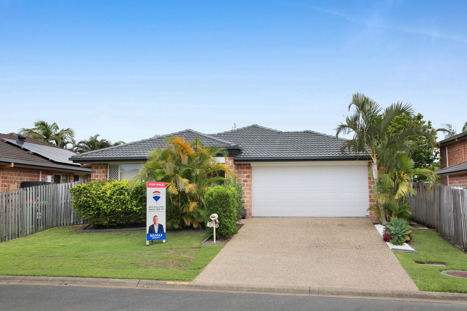 A house with a for sale sign in front of it