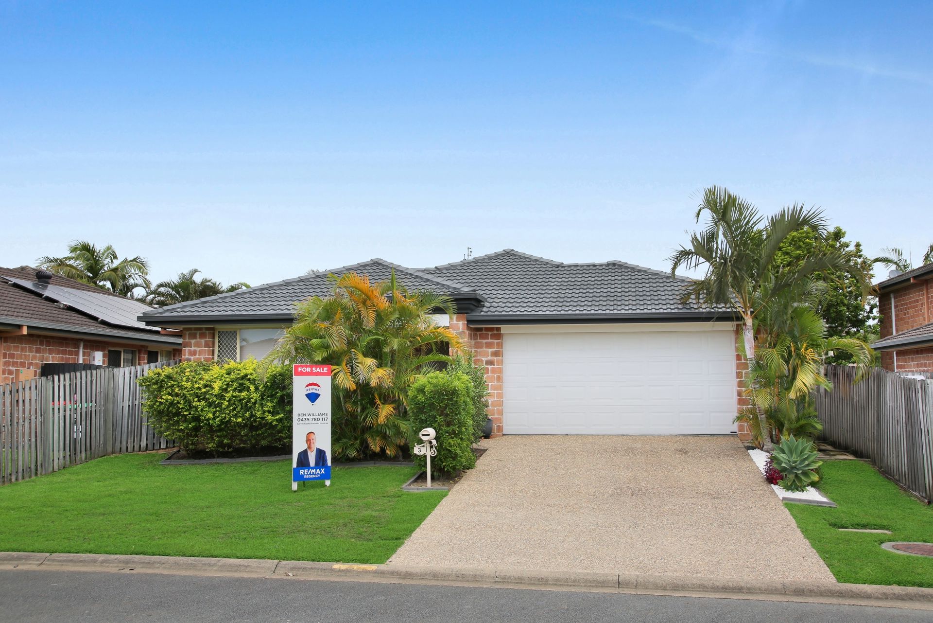 A house with a for sale sign in front of it