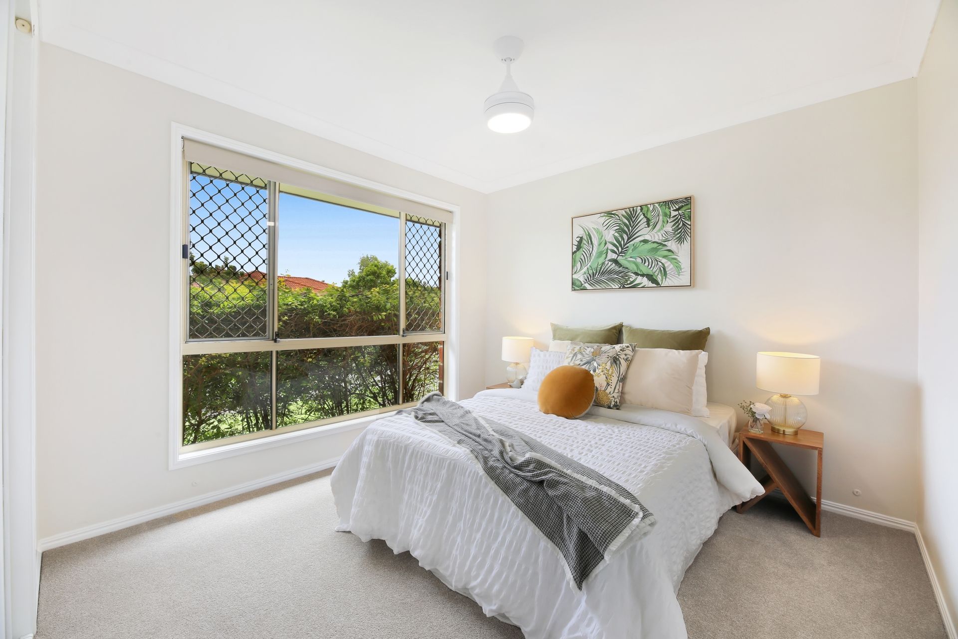 A bedroom with a large bed and a window