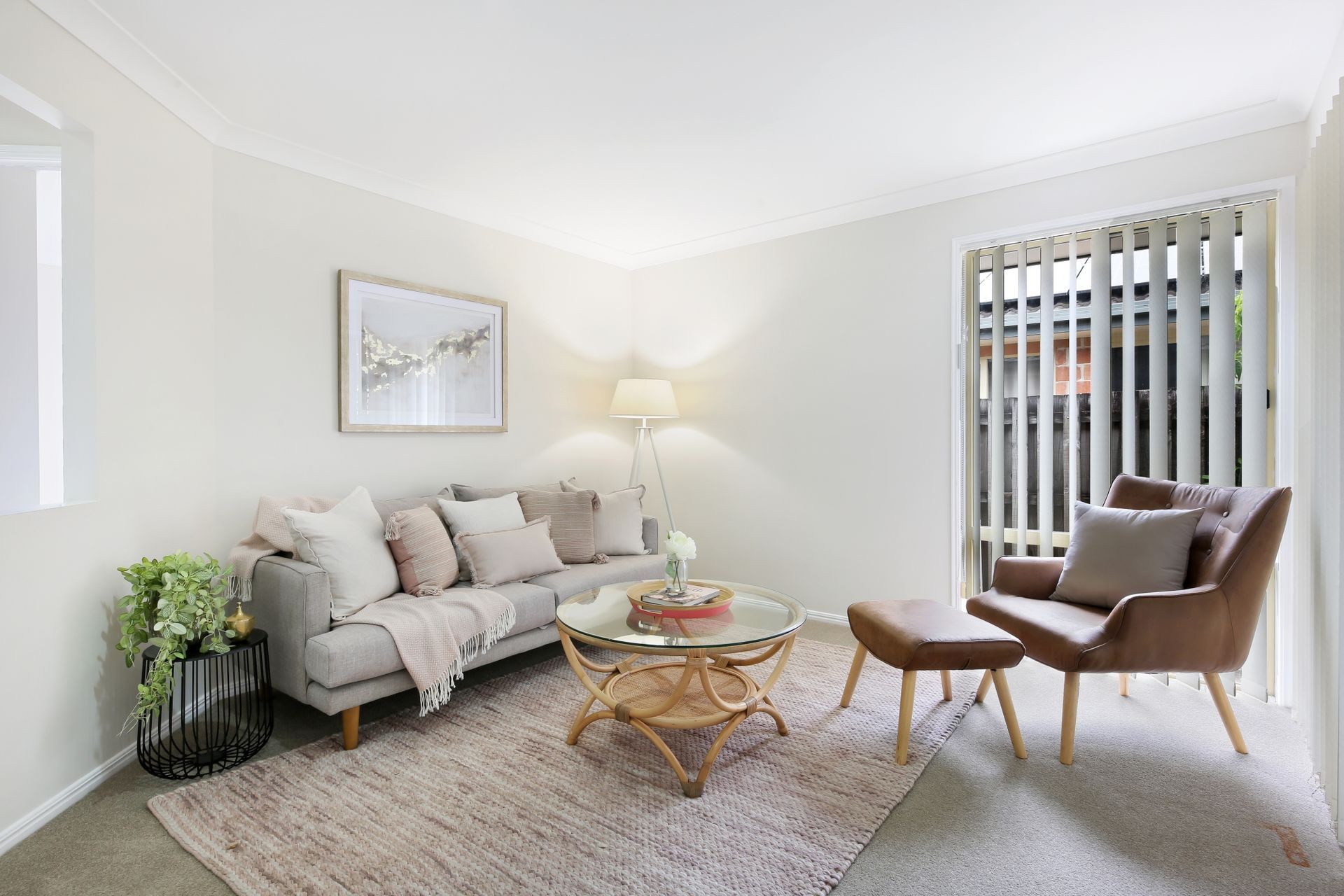 A living room with a couch , chair , coffee table and rug.