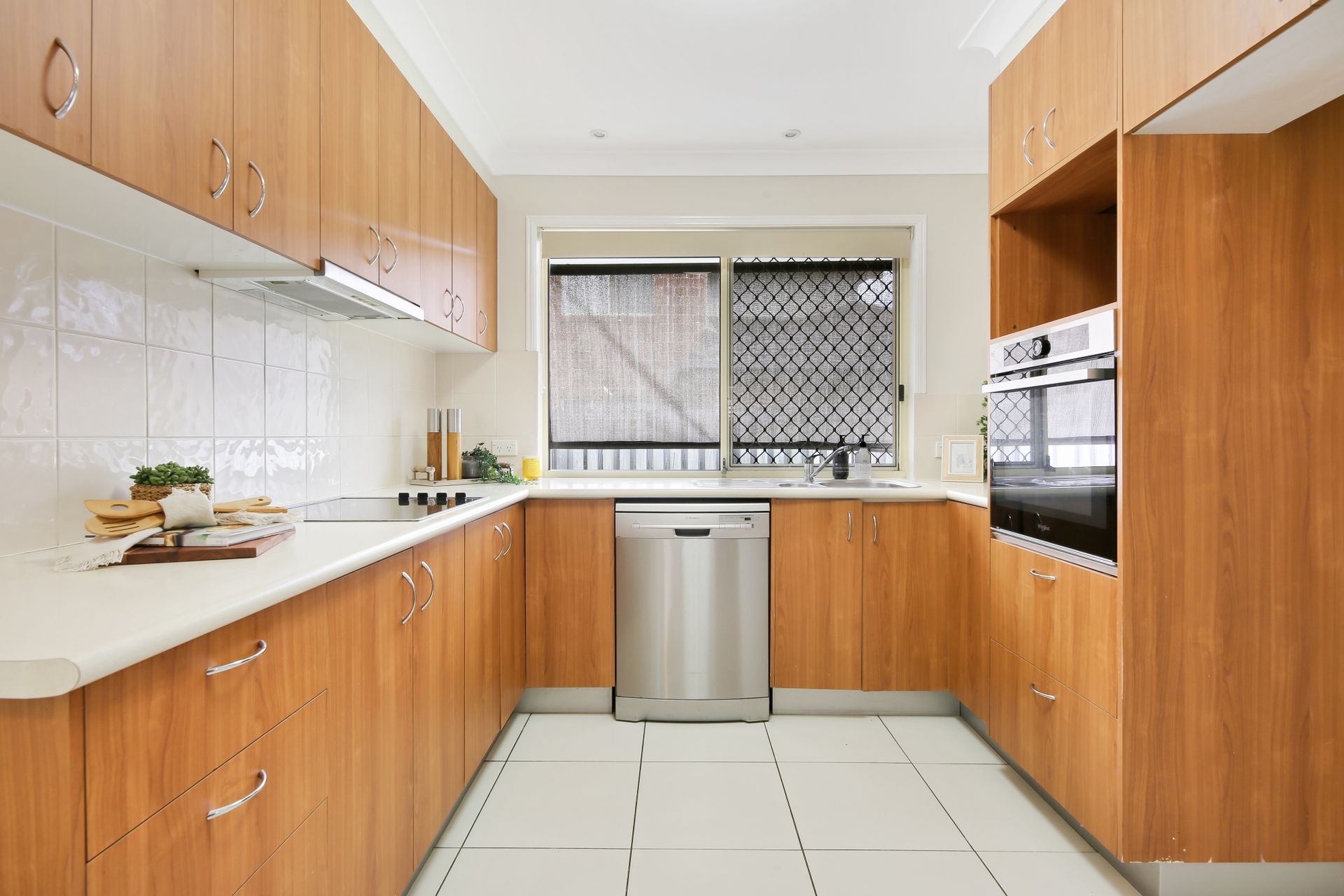 A kitchen with wooden cabinets and stainless steel appliances.