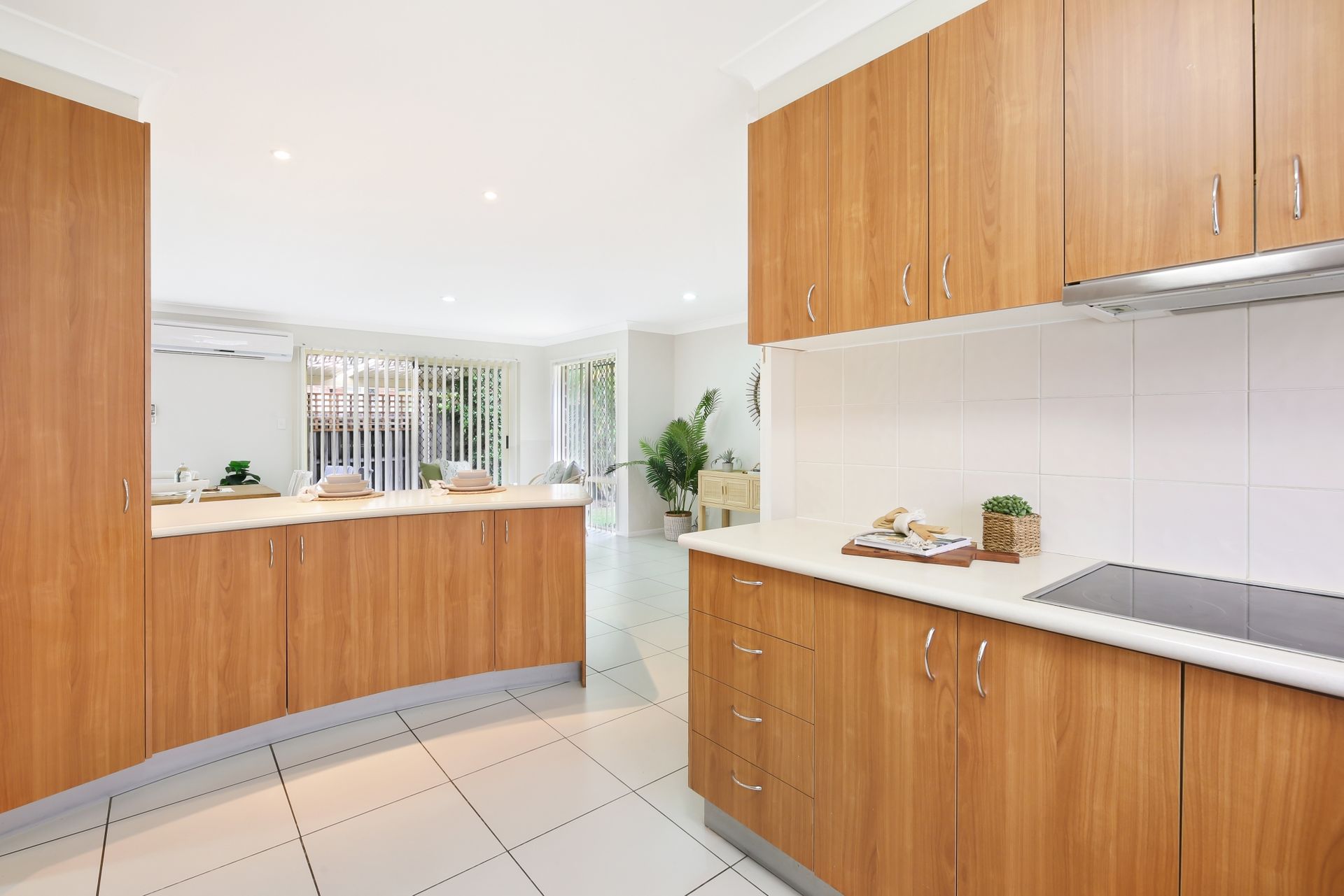 A kitchen with wooden cabinets and a stove top oven.