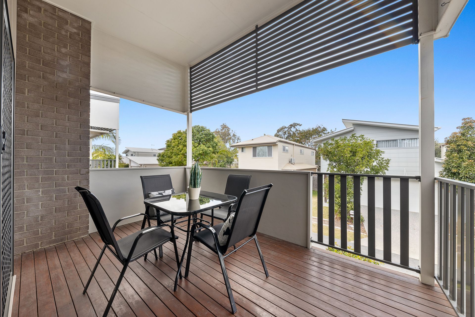 A balcony with a table and chairs on it