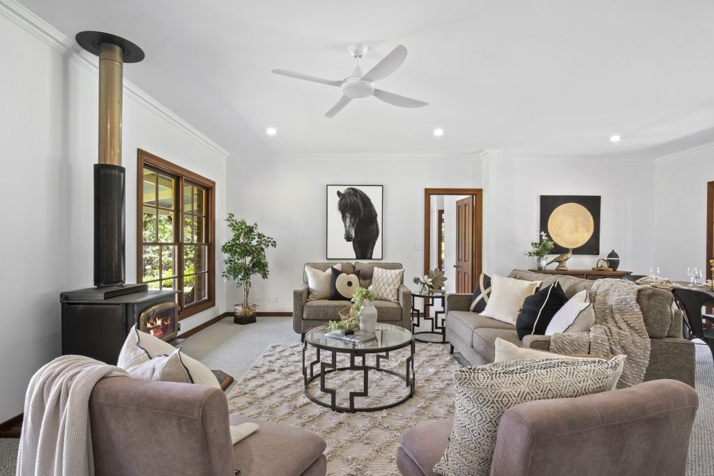 A living room filled with furniture and a ceiling fan.