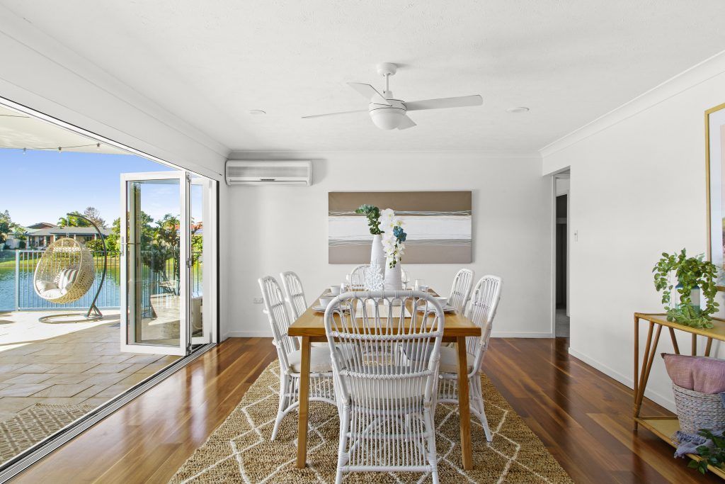 A dining room with a table and chairs and a ceiling fan.