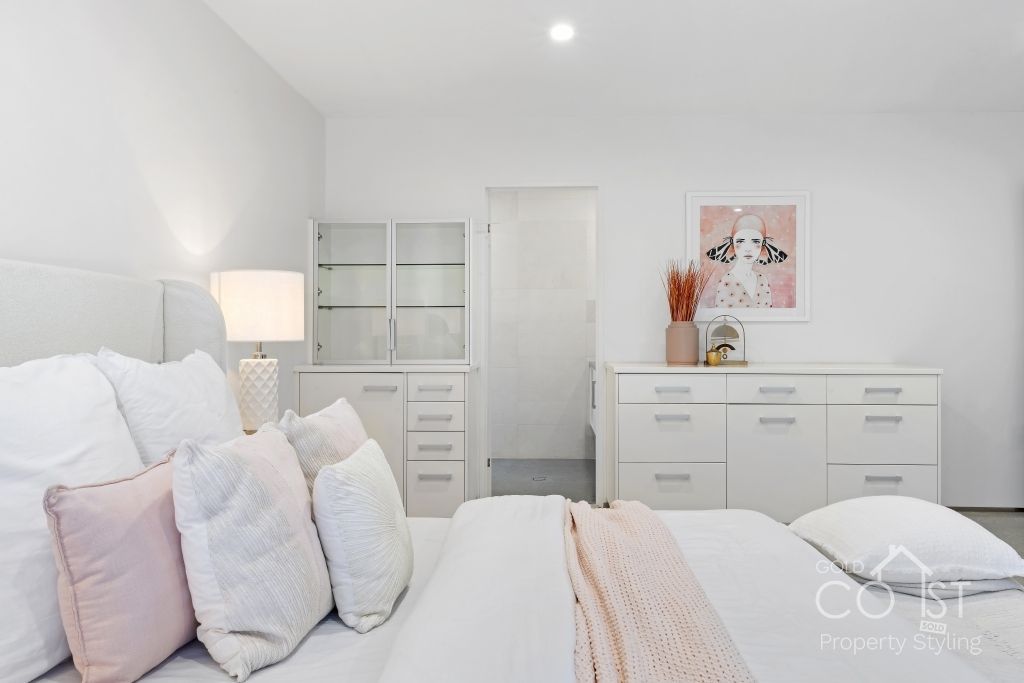 A bedroom with a large bed and lots of pillows