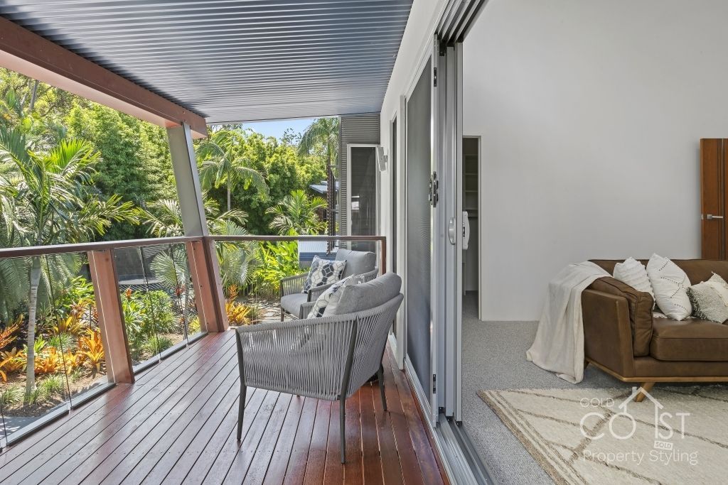 A large deck with a couch and chairs on it