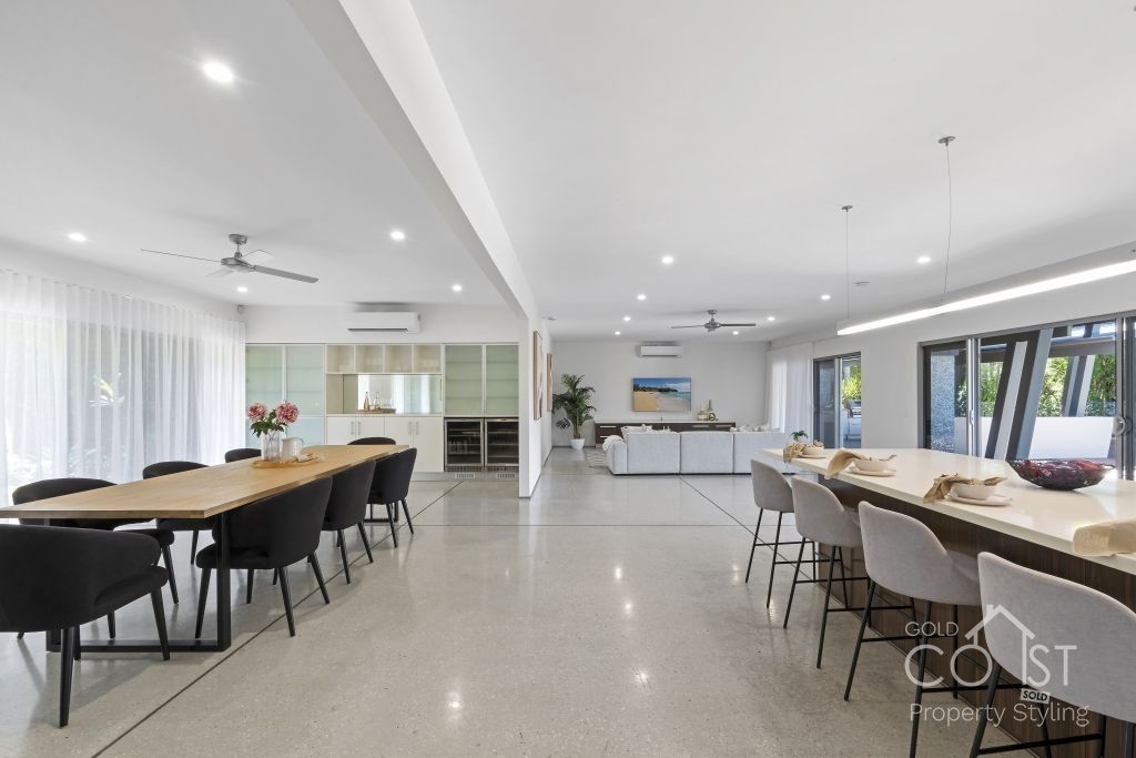 A large room with a long table and chairs in it.