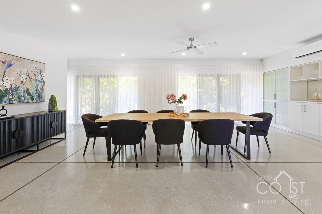 A large dining room with a long table and chairs