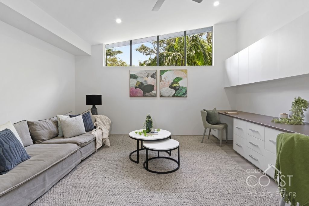 A living room with a couch and two coffee tables.