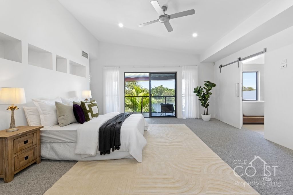 A bedroom with a large bed and a ceiling fan