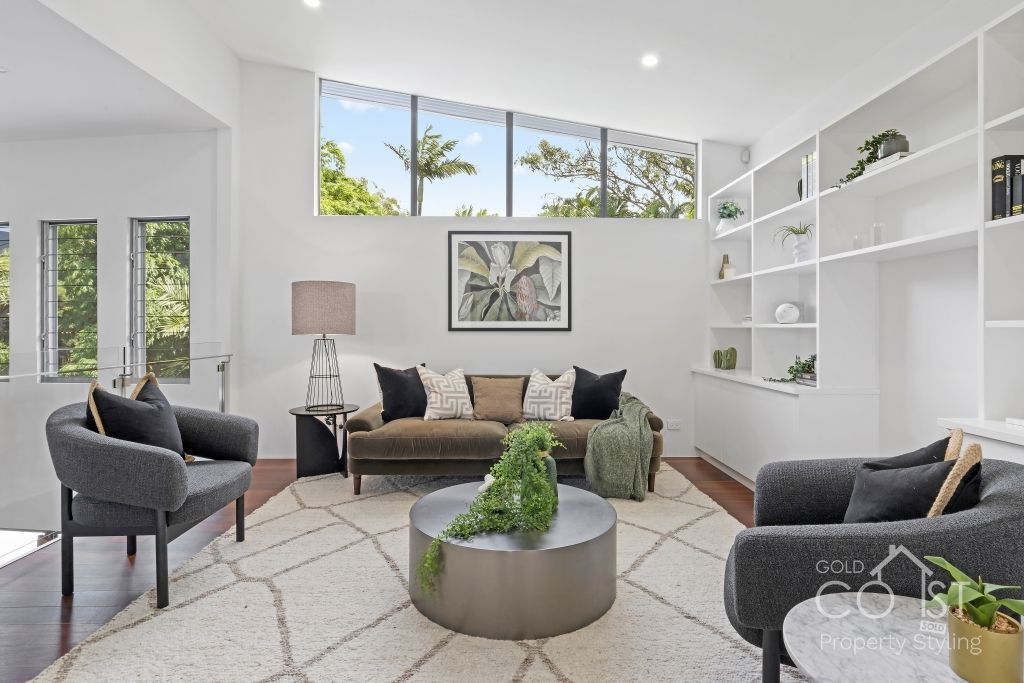 A living room with a couch , chairs and a coffee table
