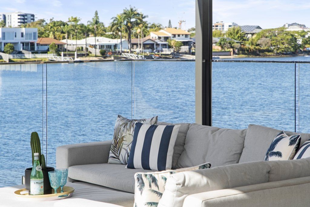 A living room with a couch and a view of the water