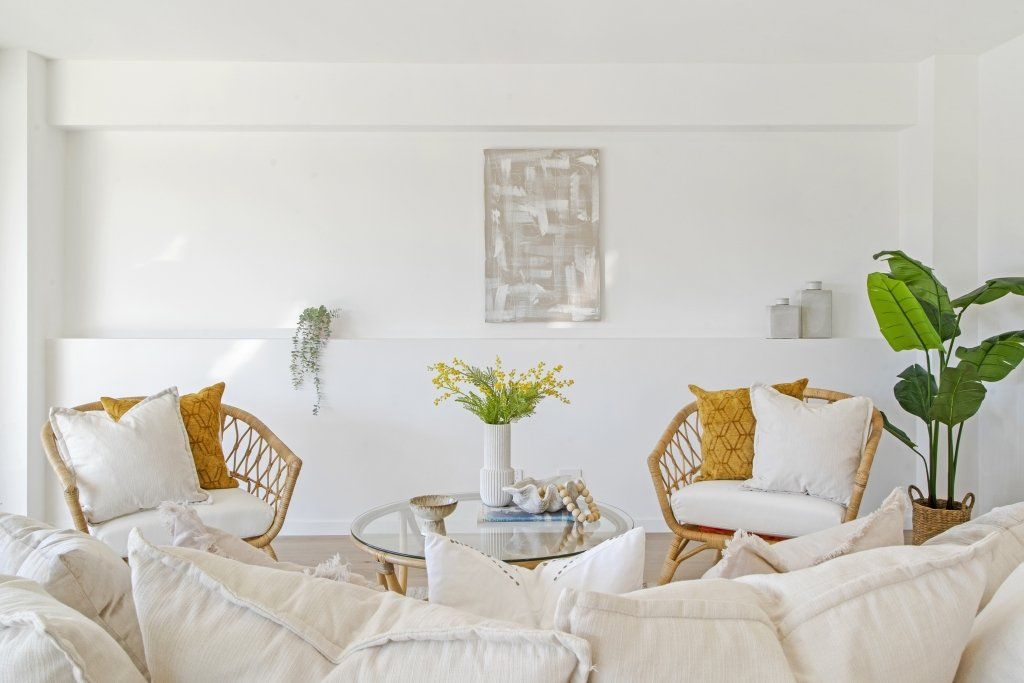 A living room with a couch , chairs , and a table.