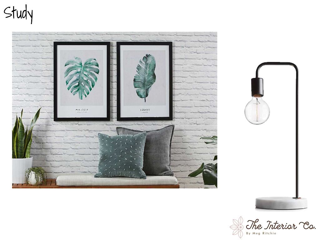 A picture of a living room with a lamp and two paintings on the wall.