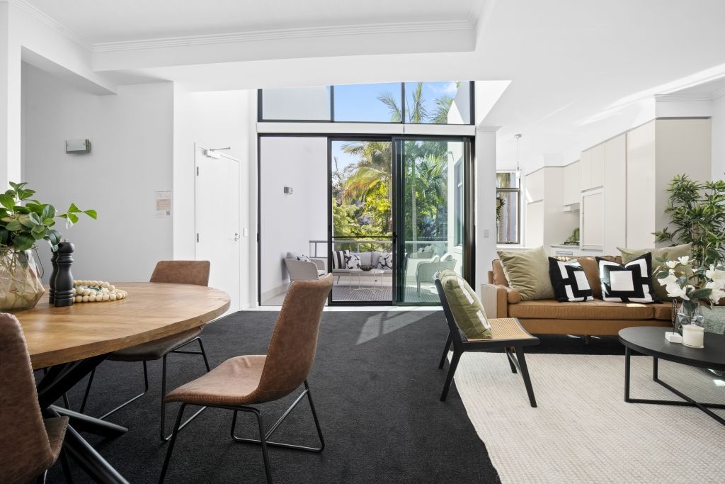 A living room with a table and chairs and a couch